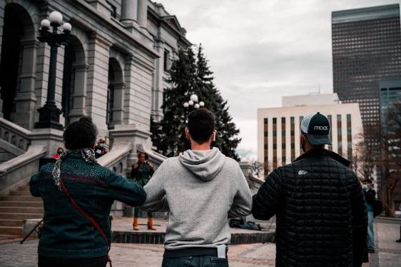 Men in front of CO Capitol